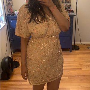 A nude color dress with sequins